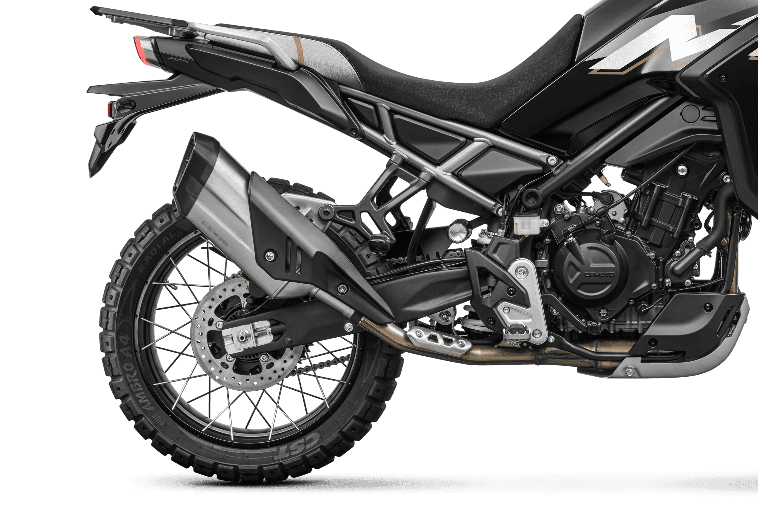 Close-up of the rear wheel, exhaust, and swingarm of a black adventure motorcycle.