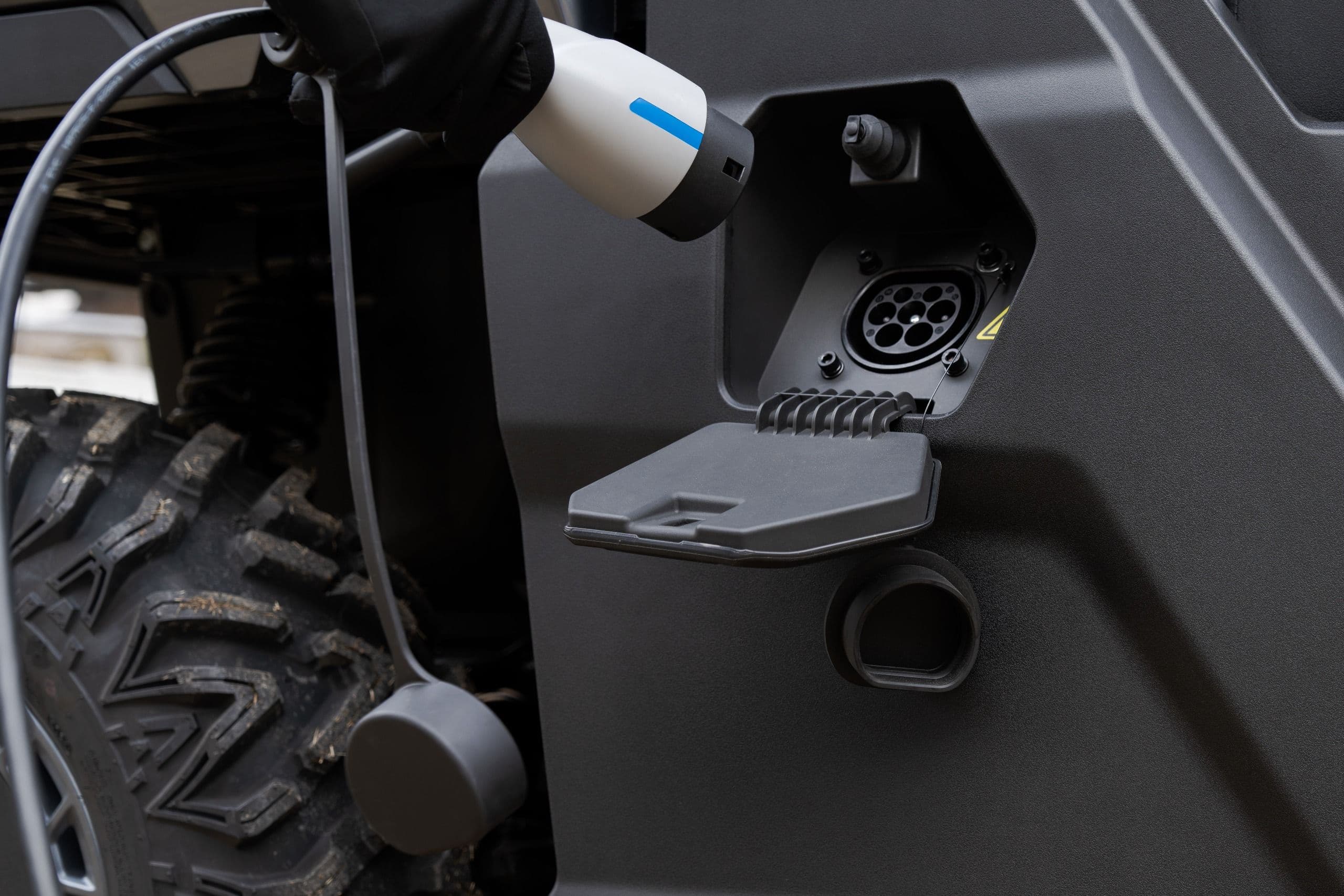 Electric charging cable plugged into the UTV's charging port.